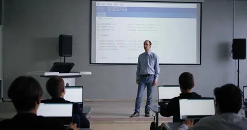 Male Teacher Of Programming And Computer Science Speaking In Classroom With Stock Footage 280174486