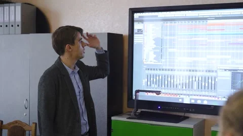 Male teacher using an interactive whiteboard in an empty classroom teaching Slow Stock Footage 213606791