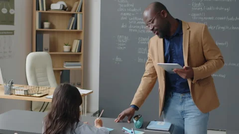 Male Teacher Walking from Board to Help Students Stock Footage 244695453