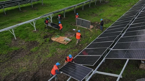 Male team engineers installing solar photovoltaic panel system Stock Footage 235641153