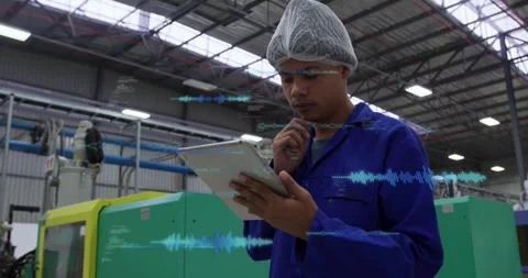 Male tech checking plant data on tablet beside green machine, tapping screen and Stock Footage 331026568