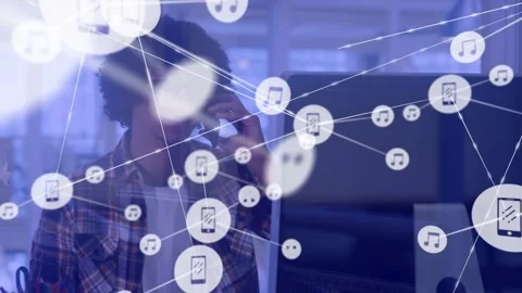 Male tech developer responding to network graphics, reaching for phone and Video stock 334182989