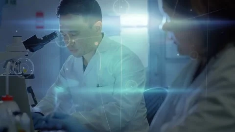 Male tech handling samples by microscope while live data activating blue nodes Stock Footage 330653205