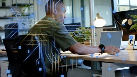 Male tech worker scrolling phone then opening laptop for data while circuitry Stock Footage 330032147