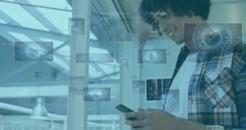 Male tech worker tapping smartphone, activating AR tiles and code-like HUDs Stock Footage 331085100