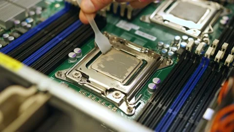 A male technical engineer in a server hardware assembly room applies thermal pas Stock-Footage 208297253