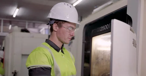 Male technician checking cnc machine system with concentration during Stock Footage 314305721