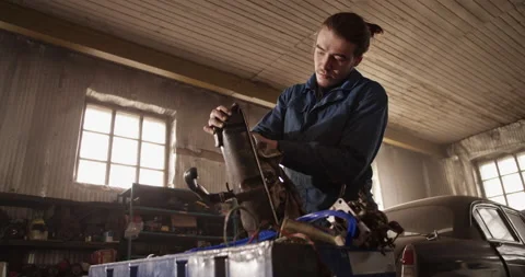 Male technician cleaning engine part Stock Footage 221108031