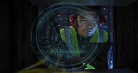 Male technician leaning into server rack, tapping tablet and initiating cyber Stock Footage 330547143