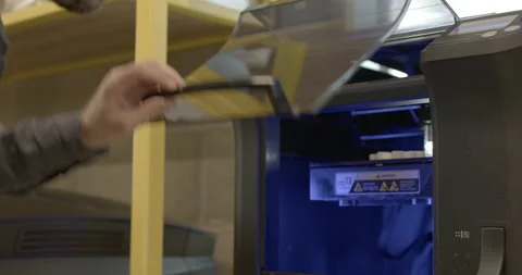 Male technician looking at 3D printer Stock Footage 165081011