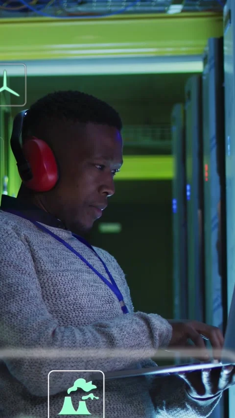 Male technician pointing at server rack activating UI icons, typing on laptop Stock Footage 332845614