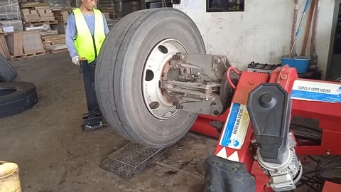Male Technician Worker Replacing Old Tire With Modern Machine Stock Footage 309306909