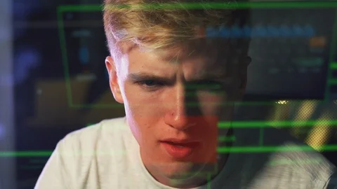 Male Teenage Hacker With Data Reflected From Computer Screen Stock Footage 124570859