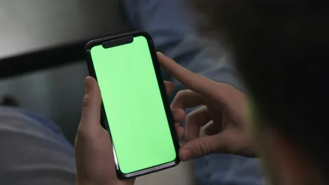 Male teenager holding mobile device cell phone green screen footage in 4k. Stock Footage