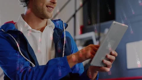 Male testing app, tapping tablet and creating binary overlay in tech office, Stock Footage 321979330