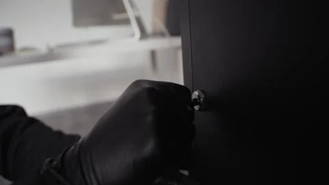 Male Thief Cracking Lock with Lockpicks then Opening Safe while Robbing Office Stock Footage 313553974