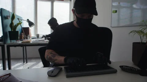 Male Thief Hacking into Computer while Spying in Corporate Office Stock Footage 313549086