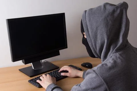 Male thief stealing data from computer Stock-Fotos