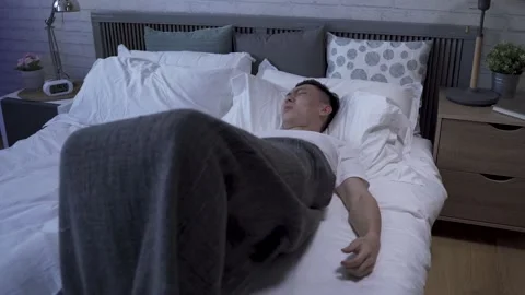 Male tossing and turning on bed Stock Footage