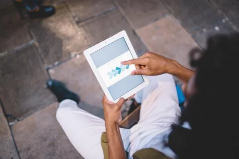 Male with touch pad technology using 4g internet connection for browsing media Stock Photos