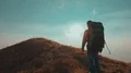 The male with a tourist backpack walking on the mountain 4k or 4k+ Resolution
