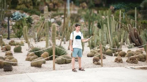 A male tourist is looking for a way on the map. Against the background of cac Stock Photos