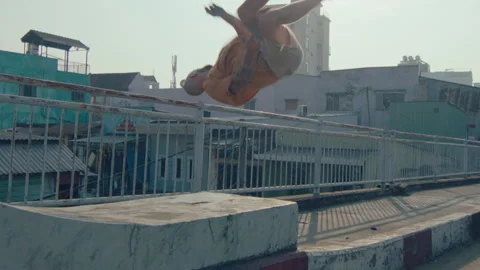 Male Traceur Doing Side Flip During Outdoor Parkour Practice Video stock 242102010