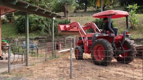 Male on tractor rearing back with caution Stock Footage 57403457
