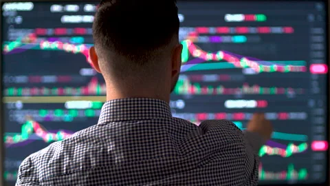 Male trader working with set for analyzing financial statistics and market data. Stock Footage 198895914