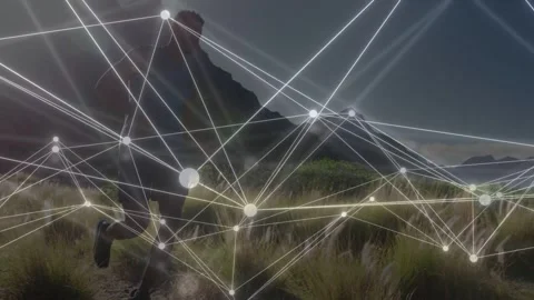 Male trail runner tapping watch, causing network nodes showing health data and Stock Footage 334242370