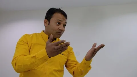 Male trying to make someone off camera understand with animated hand and arms ge Stock Footage 100027345