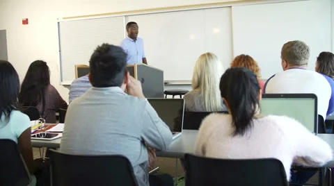 Male Tutor Teaching University Students In Classroom Stock Footage