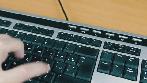 Male typing on the computer keyboard with one hand. Close-up. Stock Footage 70171049