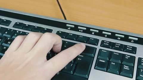 Male typing on the computer keyboard with one hand. Close-up. Stock Footage 70559704