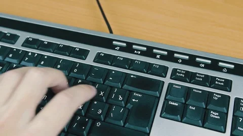 Male typing on the computer keyboard with one hand. Close-up. Stock Footage 70565496