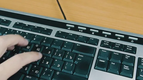 Male typing on the computer keyboard with one hand. Close-up. Stock Footage 70567294