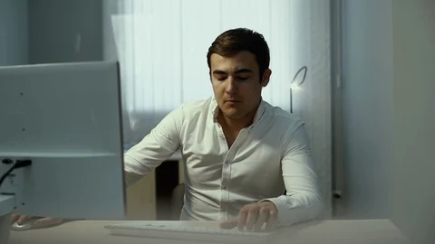 Male typing at computer in slow motion. Guy office worker is typing keyboard Video stock 111911618