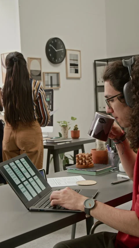 Male UI Developer Working on Wireframe Designs while Drinking Coffee Stock Footage 327907971
