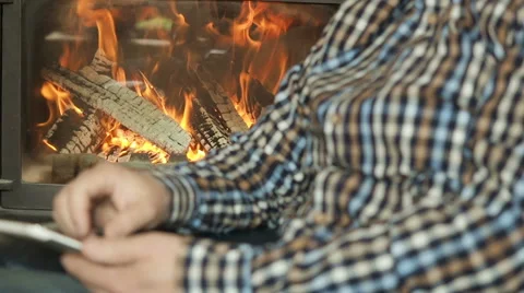 Male use tablet , background of a fireplace Stock Footage 62241446