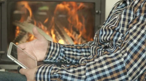 Male use tablet , background of a fireplace Stock Footage 62241763