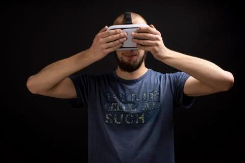 Male using 3d VR gadget is touching device with both hands Stock Photos