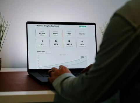Male Using Business Analytics Dashboard on Laptop Stock Photos