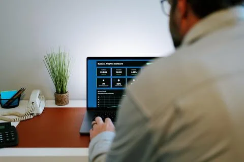 Male Using Business Analytics Dashboard on Laptop Stock Photos