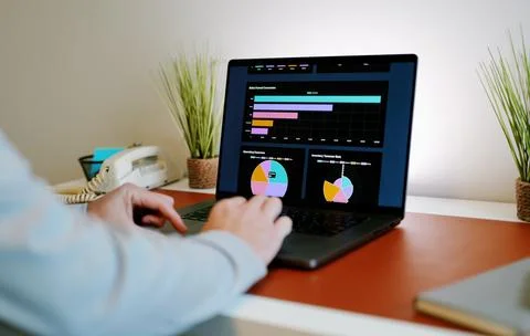 Male Using Business Analytics Dashboard on Laptop Stock Photos