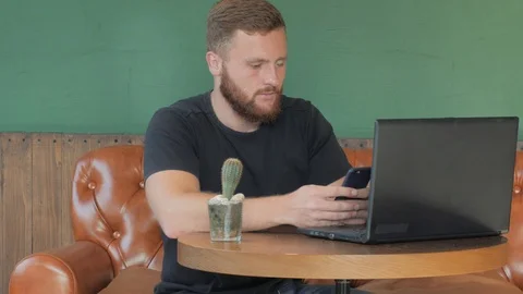 Male using laptop in cafe Stock Footage 95217691