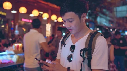 Male using mobile phone checking social media at The Khao San Road. Stock Footage 107503923
