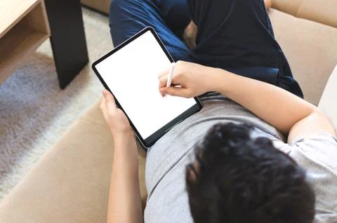 Male using stylus on tablet to draw Stock Photos