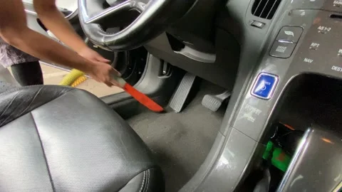 Male vacuuming inside of driver side of a car Stock Footage 210977790