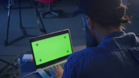 A male video editor is engaged in processing on a laptop in the studio Stock-Footage 212860030