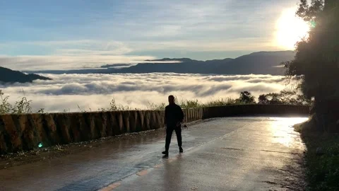 Male walking in the clouds of Benguet Stock Footage 133640213